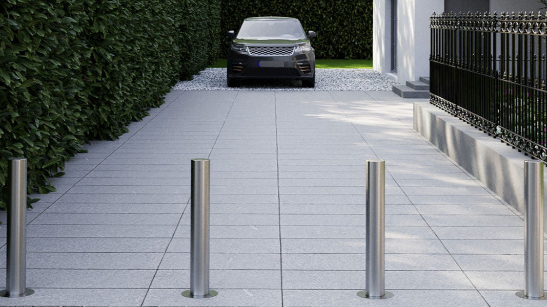 E-Go series automatic rising bollards from Pilomat installed across the entrance of a driveway