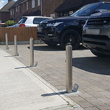 High-security telescopic bollards installed  across the entrance of a driveway for security and protection