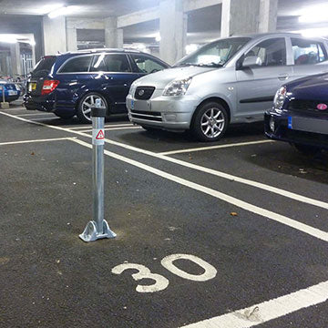 Fold down parking post protecting a private parking space