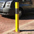 100P Removable post in Yellow with a Black band protecting a parking space.