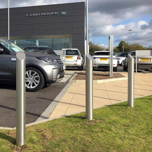 Mitre top stainless steel bollards on a vehicle forecourt