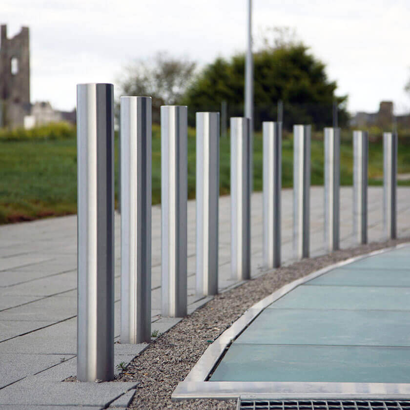 Fixed stainless steel bollards installed on a retail park