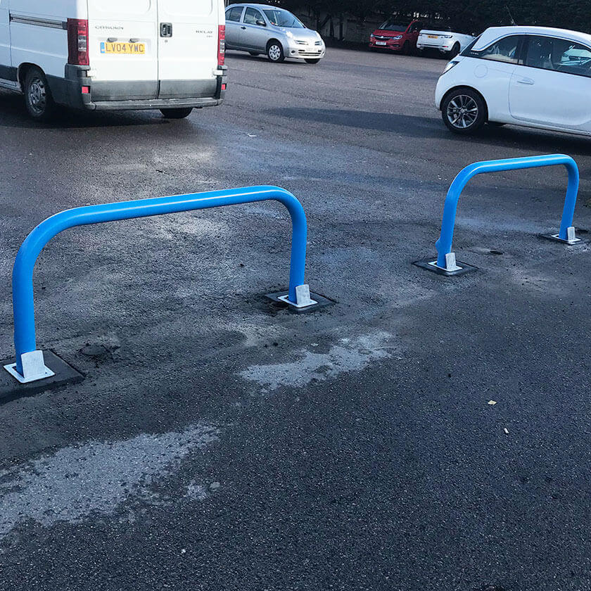 Removable steel hoop barriers across the entrance of a car park