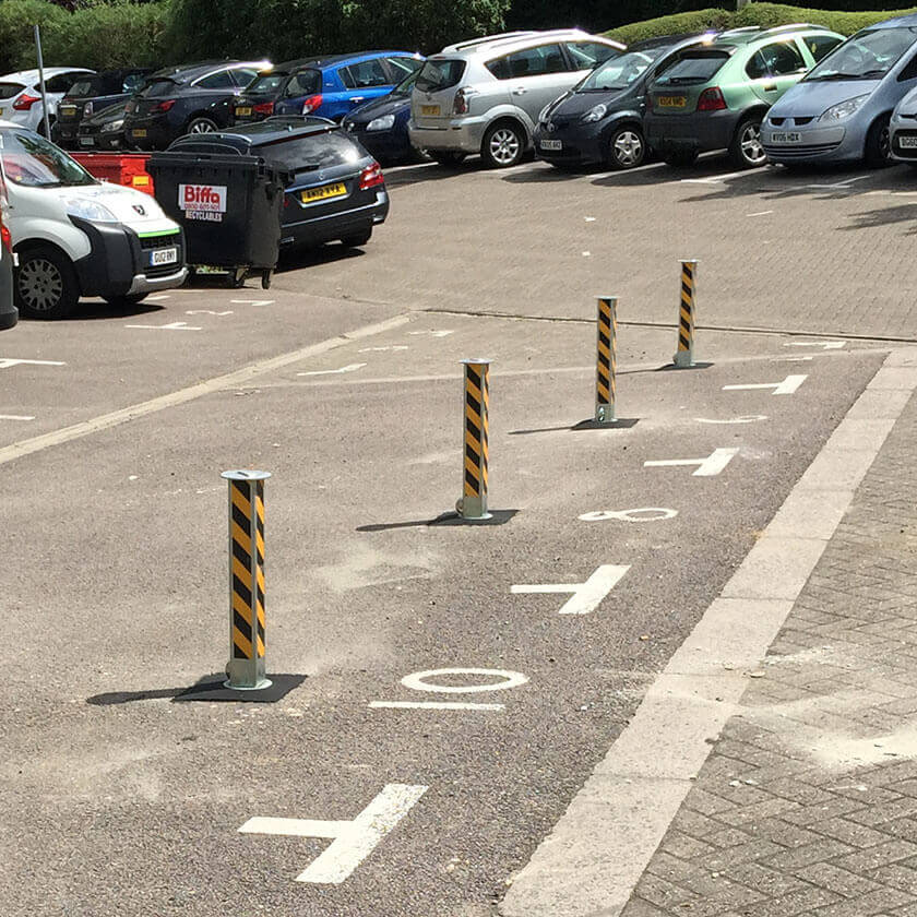 Telescopic, retractable parking posts protecting the parking spaces on a private car park