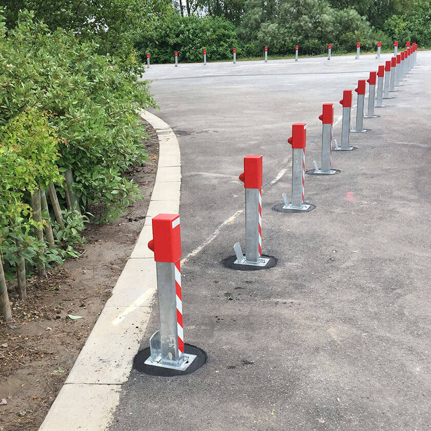 Removable, lift out steel bollards across the entrance of a private car park