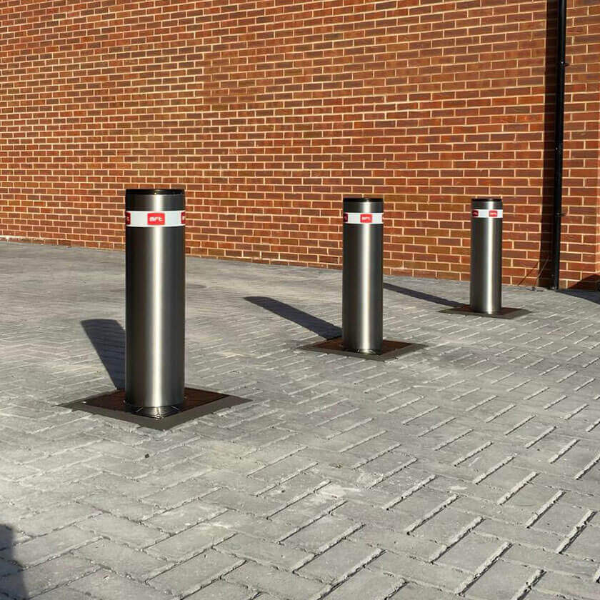 Automatic stainless steel bollards on a private driveway