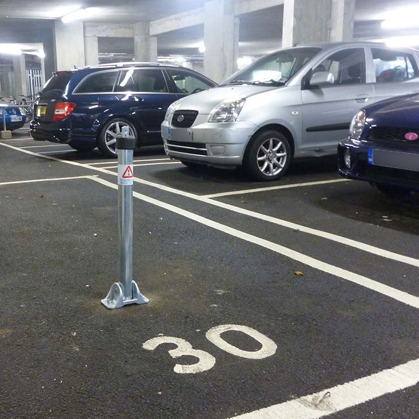 Stainless steel parking post protecting a private parking space