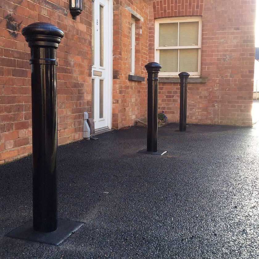 Fixed steel street bollards installed around the perimeter of a church