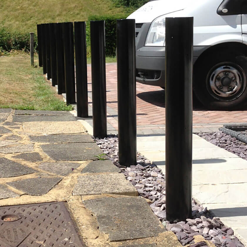 Fixed steel bollards installed on a grass verge