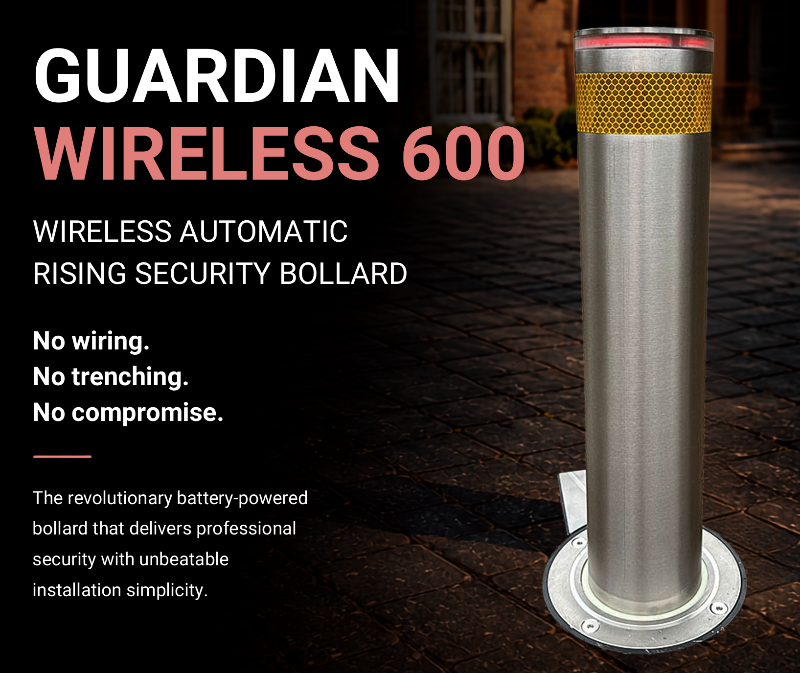 A Guardian Wireless 600 rising security bollard shown standing upright on a paved outdoor surface, with large promotional text on the left. The product is a metallic silver cylindrical bollard with a yellow textured band near the top and a red light ring at the tip.