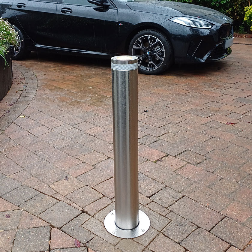 E=GO stainless steel automatic bollard installed on a block paved driveway.