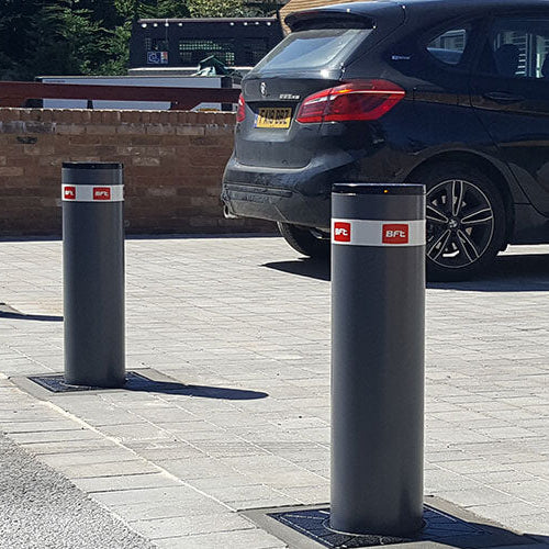 automatic rising bollards installed across the entrance of a driveway