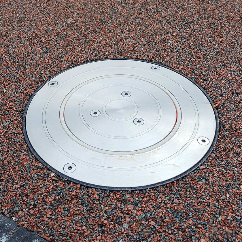 Stainless steel automatic rising bollard  showing the top plate when installed