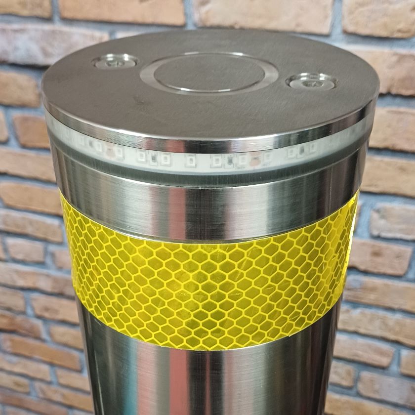 Yellow reflective band fixed to the top of the battery powered automatic bollard
