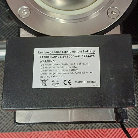 Rechargeable lithium-ion battery with warning label on a metallic surface