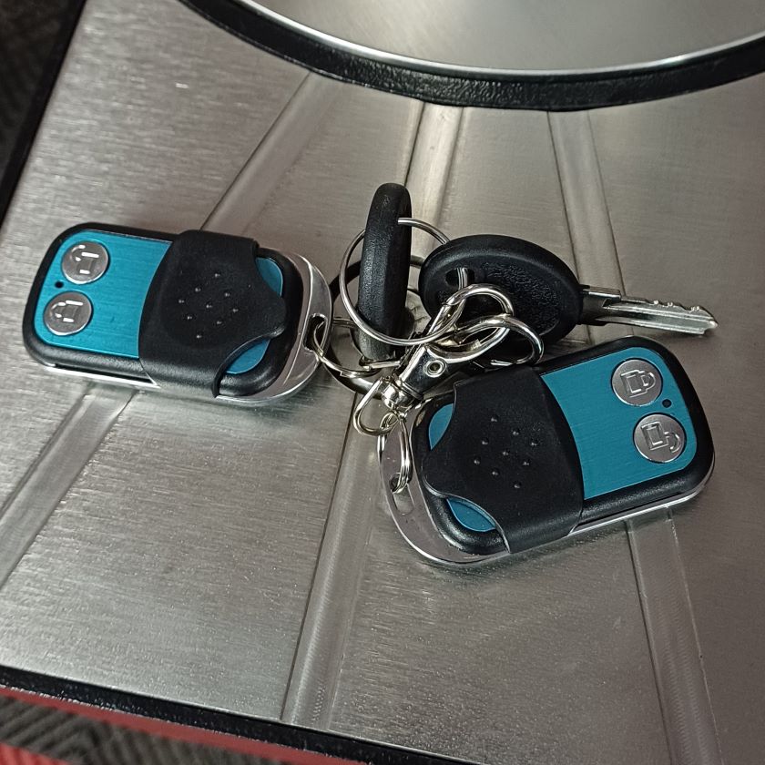 Battery enclosure with keys and 2 remote controls