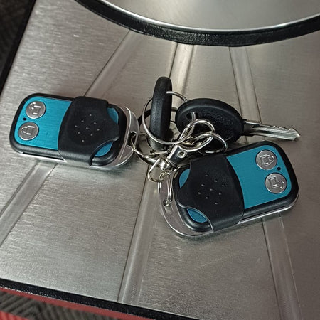 Battery enclosure with keys and 2 remote controls