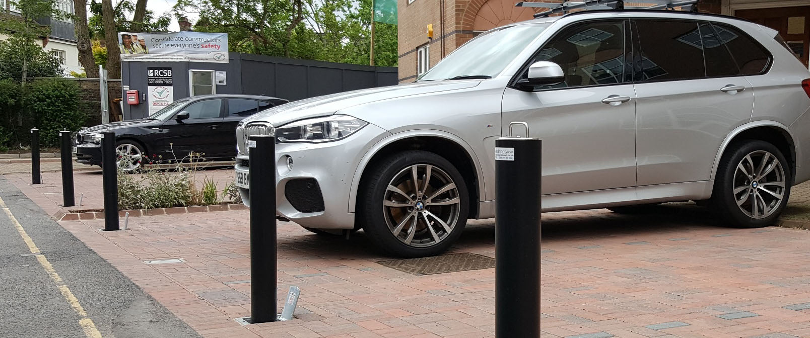 lockable telescopic car parking bollards installed on a private car park to protect private car parking spaces