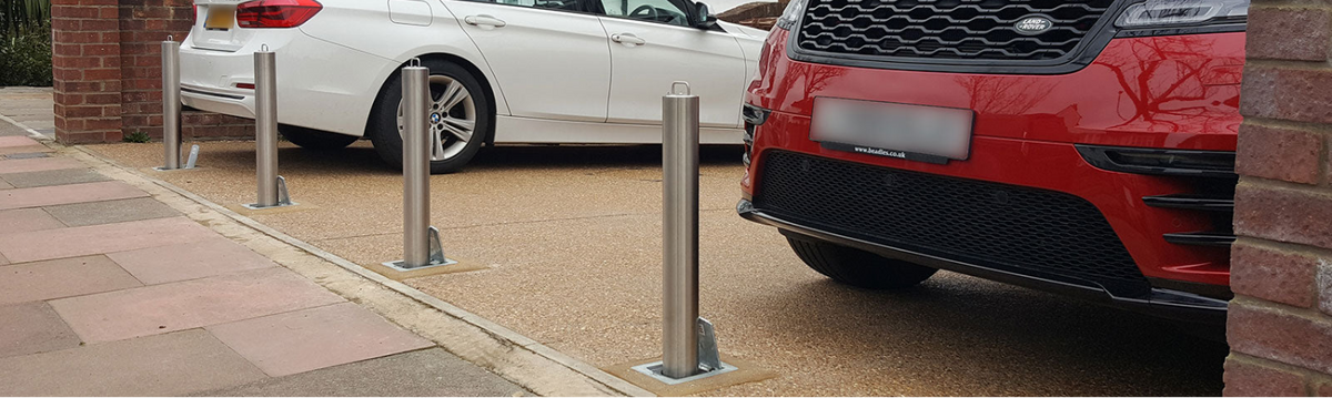 Stainless Steel telescopic bollards installed at the entrance of a driveway to protect the vehicles against the threat of theft.