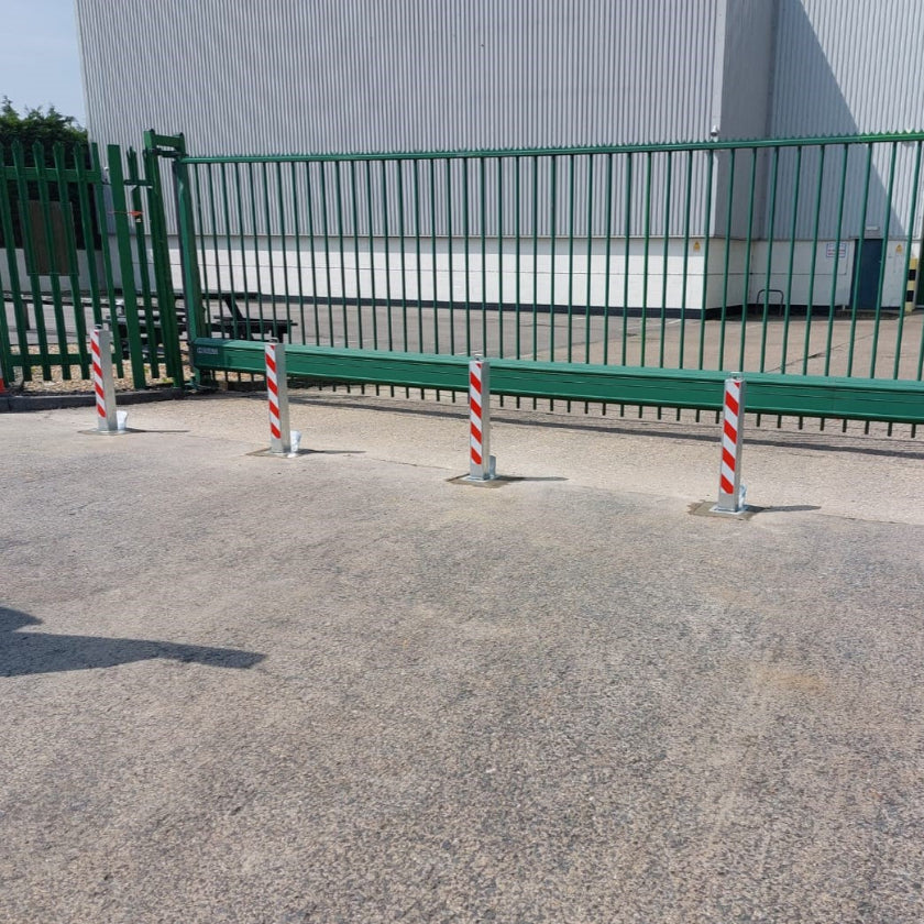 Heavy-duty telescopic bollards installed in front of a commercial building to protect against a ram-raid attack