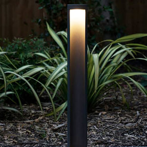 Calanda LED light bollard in a garden