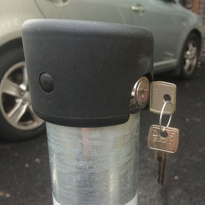 Hinged fold down parking post top lock with key inserted