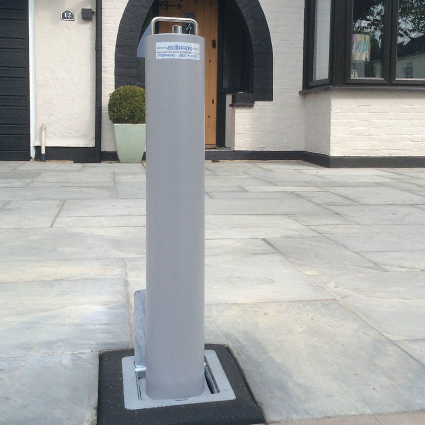 LA/114 Lift assist telescopic bollard in Silver on a natural stone driveway