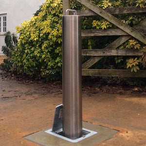 Lift assisted stainless steel telescopic bollard on a private driveway.