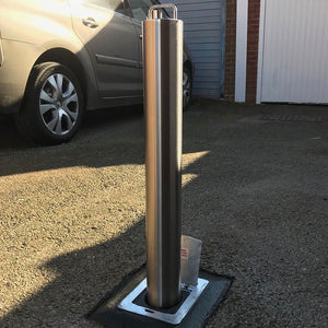 LA/S14 Lift assist stainless steel telescopic bollard on a gravel driveway